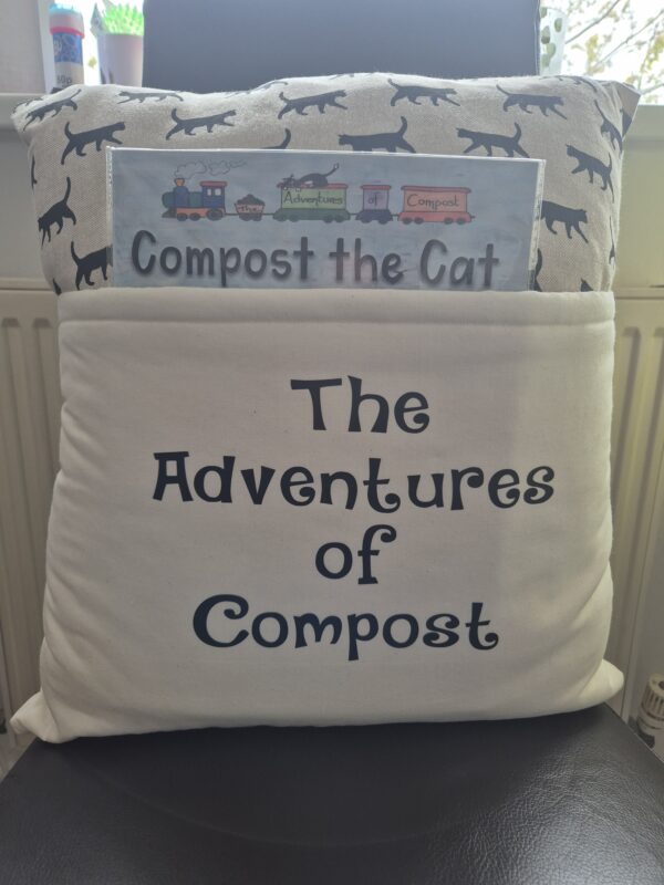 The Adventures of Compost book cushion with Compost the Cat book