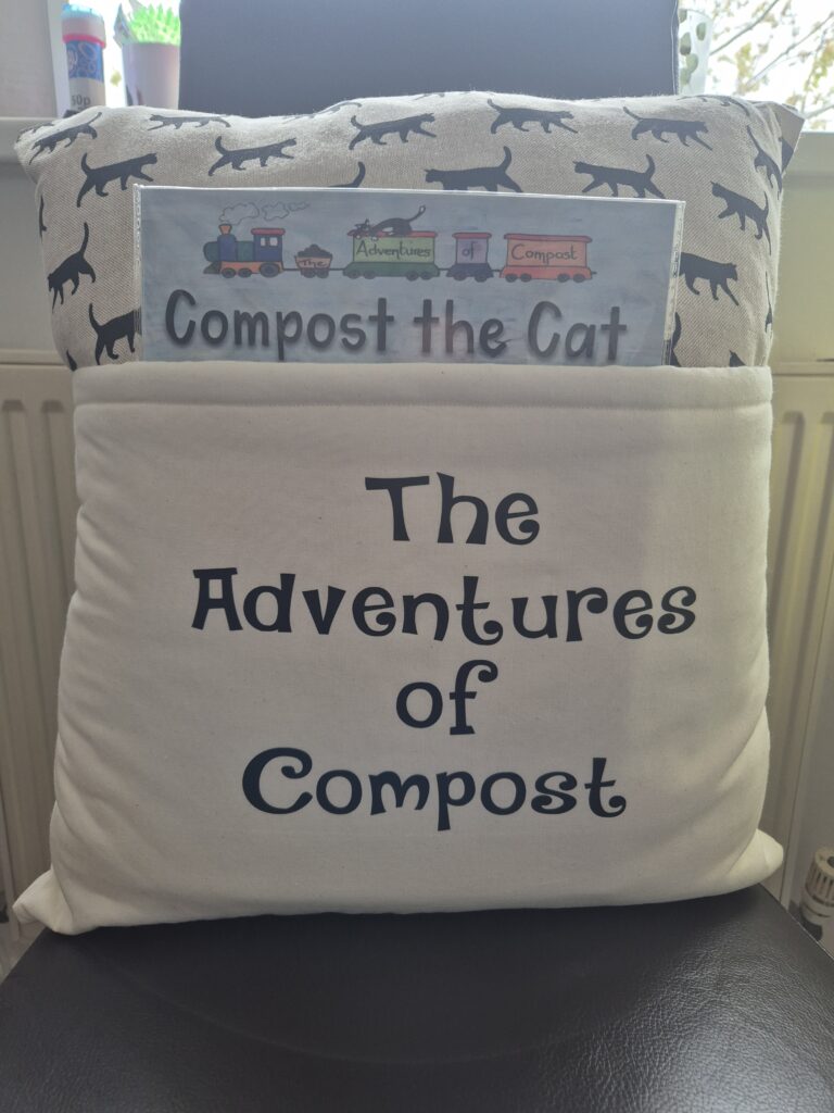 The Adventures of Compost book cushion with Compost the Cat book